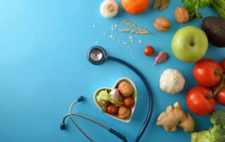 Natural dietary medicine with healthy food and stethoscope on bl